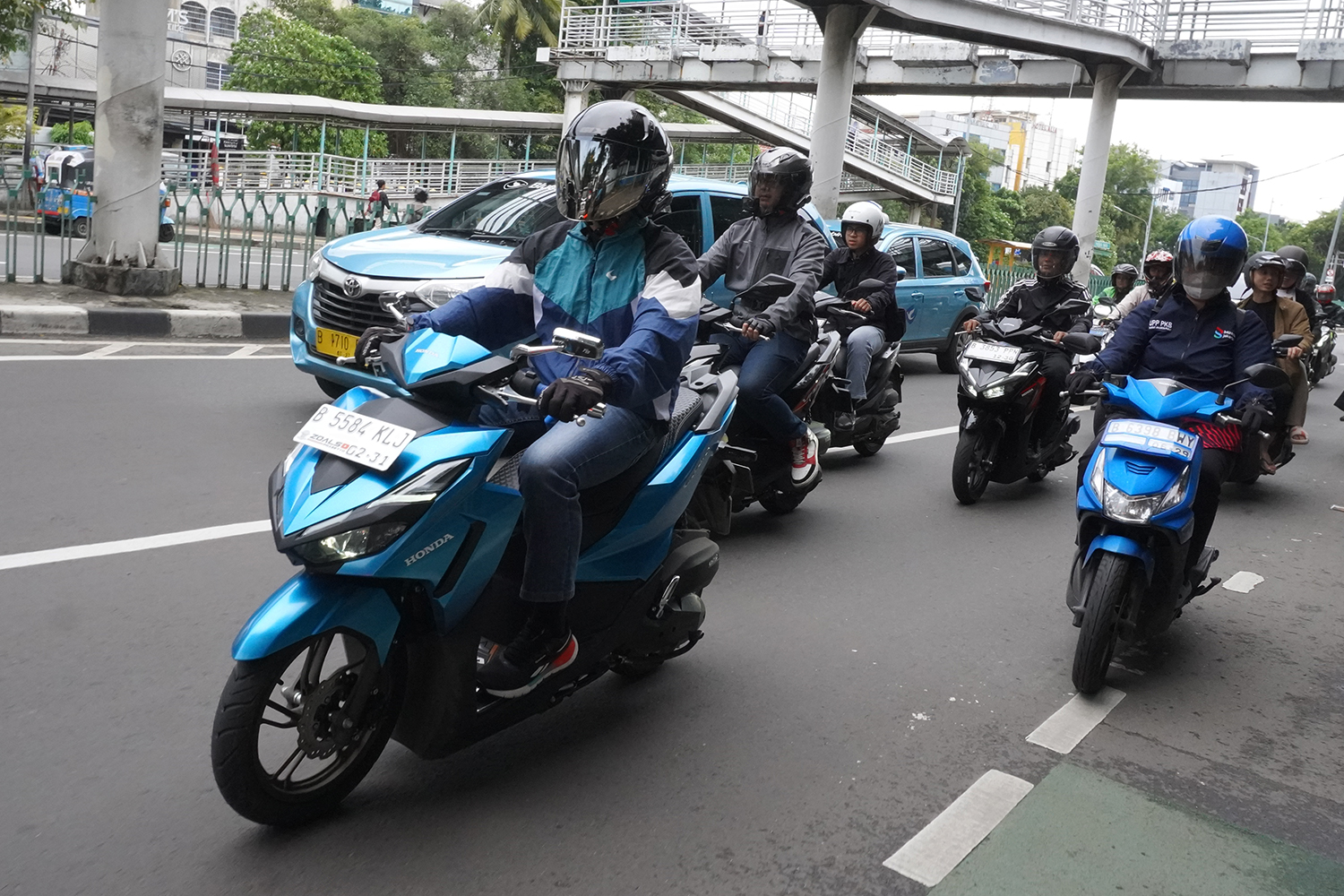Pengendara motor menepi memberi jalan untuk ambulans di jalan raya