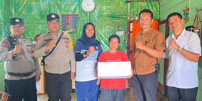 Personel Polsek Siantar Selatan menyerahkan paket sembako kepada warga di Jl. Kisaran