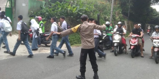 Petugas polisi mengatur lalu lintas di Jl. Singosari, Siantar Barat